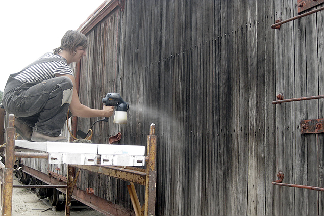volunteer spraying boxcar